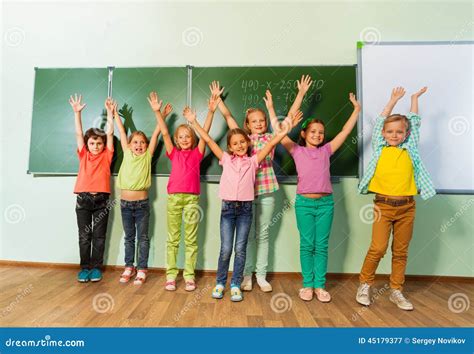 kids stand  arms     blackboard stock photo image