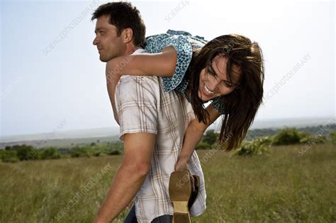Man Carrying Woman Stock Image F003 1627 Science Photo Library