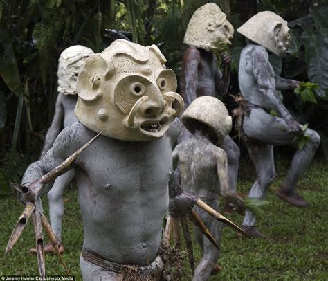 mud men of papua new guinea pictured in their clay masks daily mail online