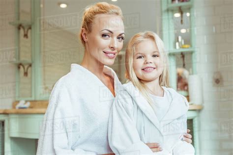 Beautiful Blonde Mother And Daughter In Bathrobes Smiling At Camera