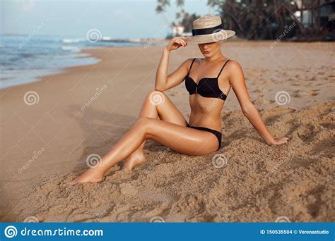 Beautiful Woman With Perfect Body In Bikini Lying On Beach Skin Care