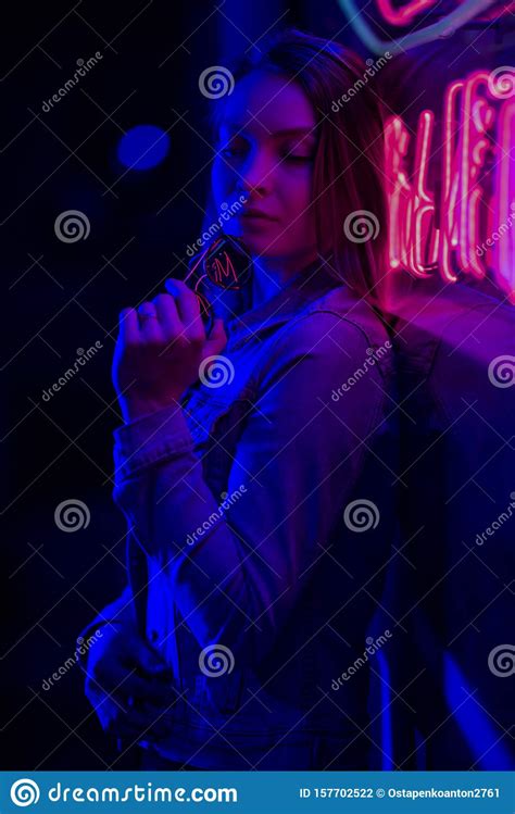 creative sexual portrait of a girl in neon lighting with