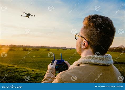 male drone pilot flying  drone quadcopter outdoors stock photo image  open aircraft