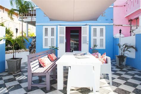 white table sitting    pink  blue building
