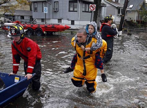 photos of people rescued from hurricane sandy firefighters brave the