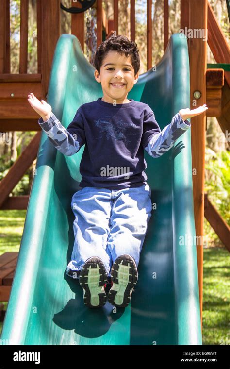boy  playground sliding    stock photo alamy