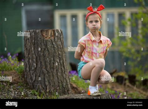 little naughty girl makes faces at the camera while sitting near