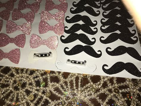 diy bows and mustache pins for gender reveal purchased hole punch off