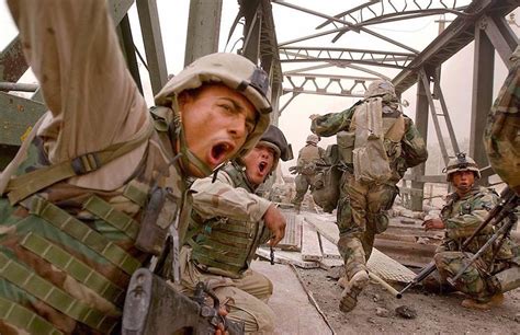 marines urge fellow infantrymen  rush   damaged bridge  fallujah  april