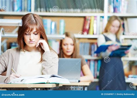 smiling young adult woman reading book  library stock image image