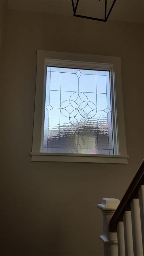 A Large Beveled All Clear Window Installed On A Staircase