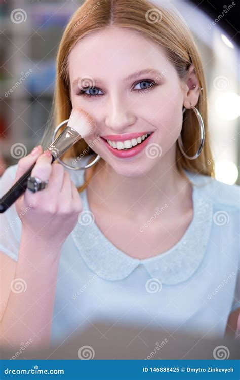 Attractive Pretty Blonde Woman Applying Beautiful Makeup Stock Image