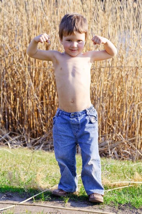 strong kid showing  muscles stock photo image  childhood body