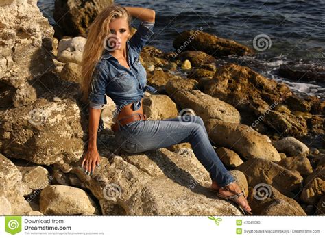 Pretty Girl With Long Blond Hair In Jeans Clothes Posing