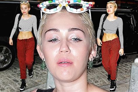 miley cyrus decorates herself with nipple tassles as she goes topless