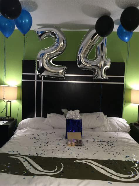 A Bed With Balloons And Streamers In The Shape Of Two Twenty Fives On It