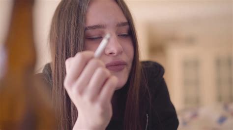 Portrait Of A Drug Addicted Woman Smoking A Cigarette Indoors