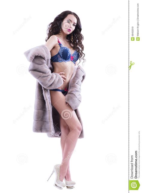 half naked girl in a fur coat on a white background stock