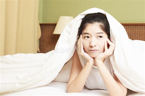 Woman Lying In Bed Underneath The Quilt And Smiling Stock Image Image
