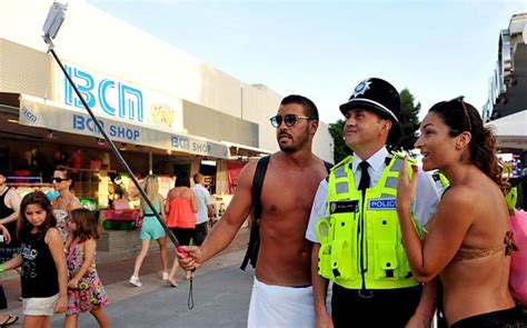 Magaluf Revellers Pose Topless With Policeman But Should