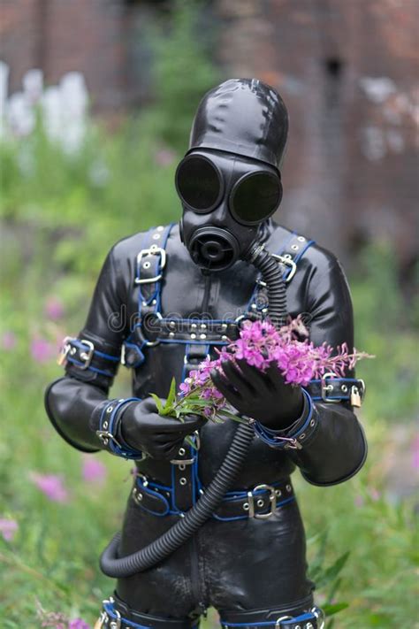 adult kinky man dressed in fetish latex rubber costume with kinky mask