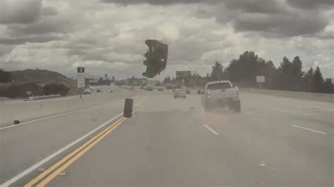 dashcam shows car catapult into air after being hit by a detached tire