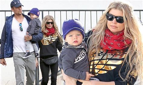 fergie and josh duhamel take turns cradling their adorable tot axl as they enjoy a cosy