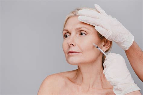 goodlooking mature caucasian woman undergoing facial beauty injections