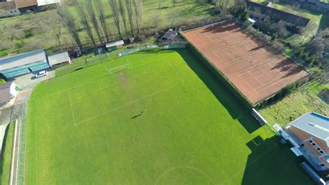 aerial  descending  soccer player  empty field high   soccer green field