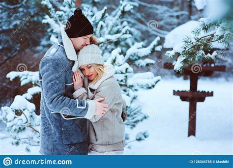 Romantic Winter Portrait Of Couple Embracing Outdoor On