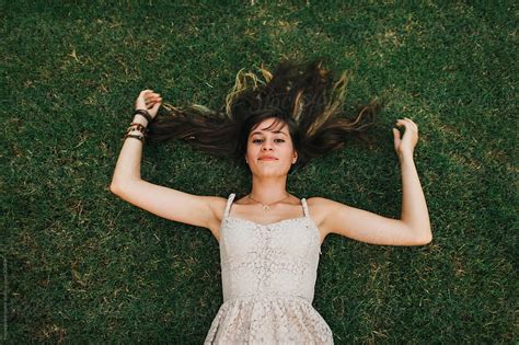 Teenage Girl Laying In Grass By Stocksy Contributor Michelle Edmonds