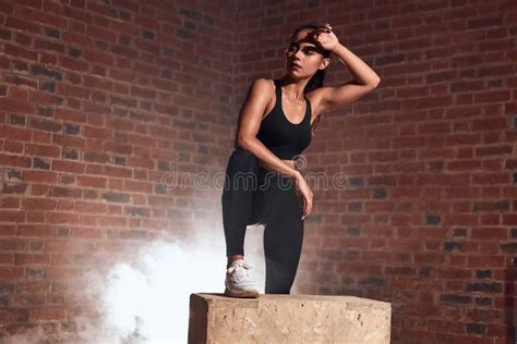 Having Rest Tired Looking Fitness Woman Standing Near Box At Gym Stock