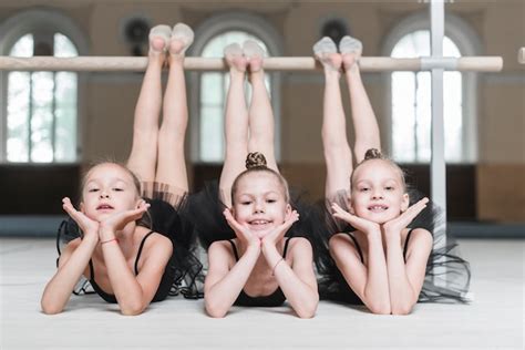 Portrait Of Three Ballerina Girls Poising In Front Of Barre Free Photo