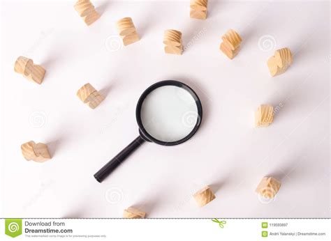 wooden figures  people lie   magnifying glass   white