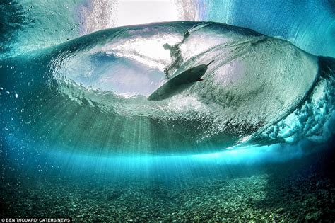 tahiti photographs of surfers taken from the bottom of a