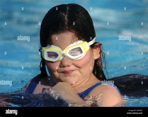 smiling over weight heavy obese girl in country club swimming pool with