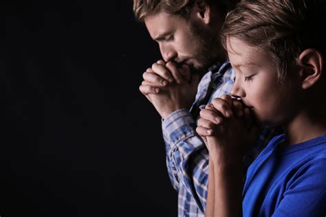 praying father  son  dark background blue ridge christian news