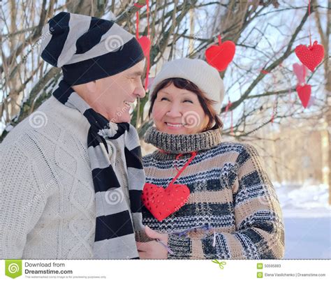 Mature Couple Of Lovers Man Presents Hearts Stock Image