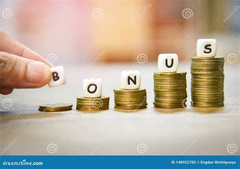 yearly bonus concept hand holding words  bonus  stack coins staircase stock photo image