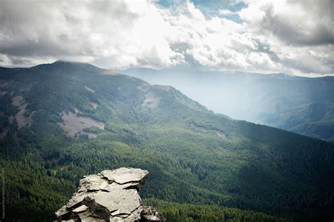 cliff overlooking forest  stocksy contributor isaac lane koval