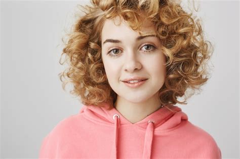 free photo close up of cheerful dreamy curly haired girl smiling