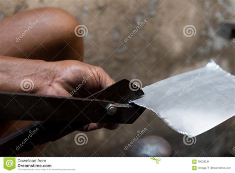 hand holding metal cutting iron sheet stock photo image  plastic