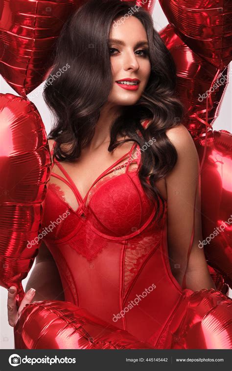 Sexy Woman In Red Lace Lingerie And Balloons With Hearts Posing In The