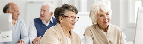 Two Older Women Using Computer Newfoundland And Labrador Laubach
