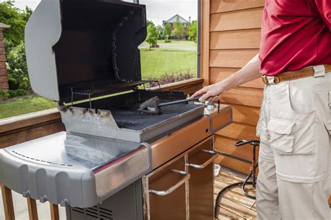 man maintaining  grill adams gas