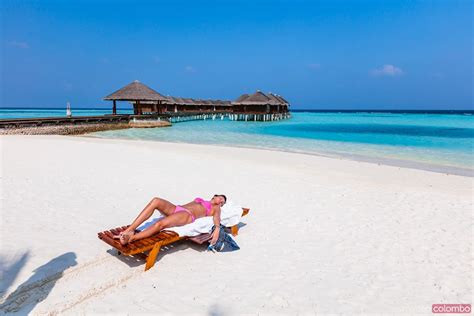 woman sunbathing  lounge chair maldives royalty  image