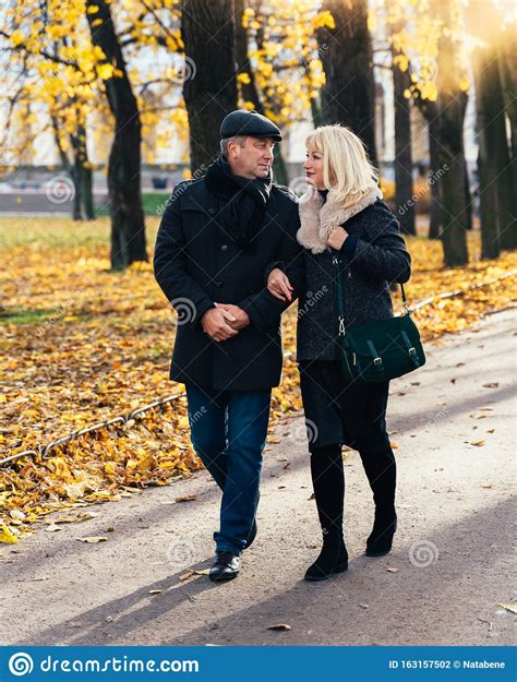 Happy Blonde Mature Woman And Handsome Middle Aged