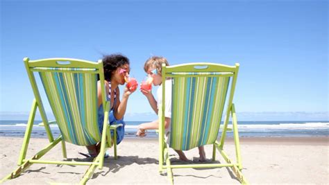 Couple Sitting In Beach Chairs With Tropical Drinks Stock