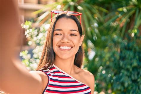 Young Latin Girl Smiling Happy Making Selfie By The Camera At The City