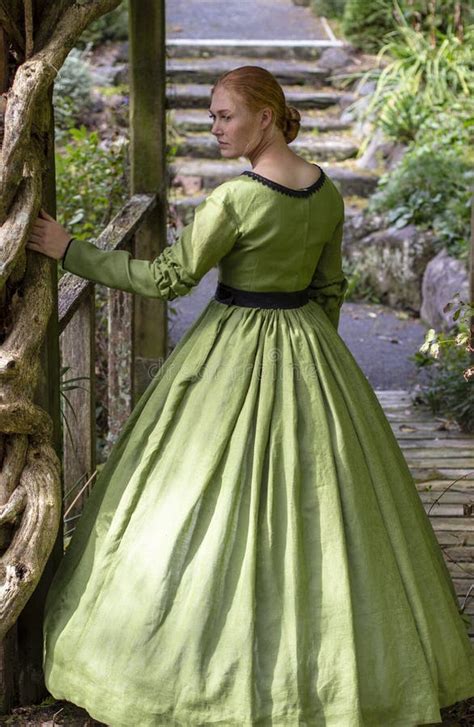victorian woman in green dress walking in garden stock image image of